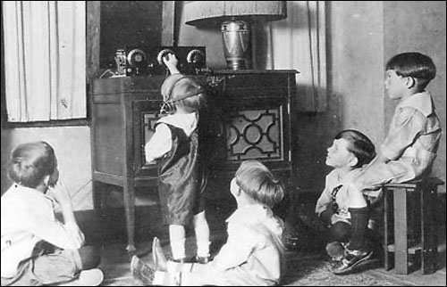 Children in Calgary, Alberta, sitting around and listening to the radio in the 1920s