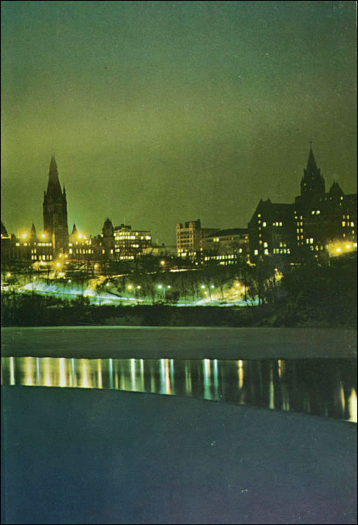 Une photo de nuit des édifices du parlement de la rivière Ottawa.