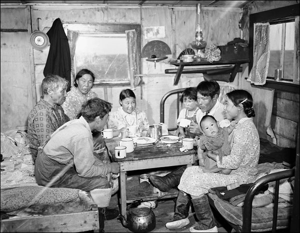 Jimmy Gibbons, Inuit deputy RCMP constable at home with his family at Eskimo Point, N.W.T.