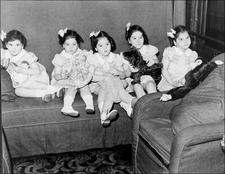 Dionne quintuplets in their train car, on trip to Toronto, Ontario