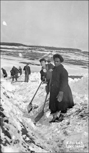 Workers digging a surface gutter on the Garrison Games grounds, looking east, Halifax, December 1934