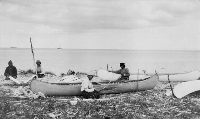 A group of Innu making their canoes at the North West River in Labrador, circa 1920