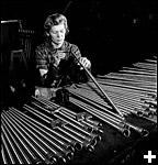 Former orthopedist Evelyn Saunders of Timmins, Ontario, now working in the John Inglis Company plant manufacturing Colt-Browning gun barrels