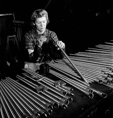 Former orthopedist Evelyn Saunders of Timmins, Ontario, now working in the John Inglis Company plant manufacturing Colt-Browning gun barrels